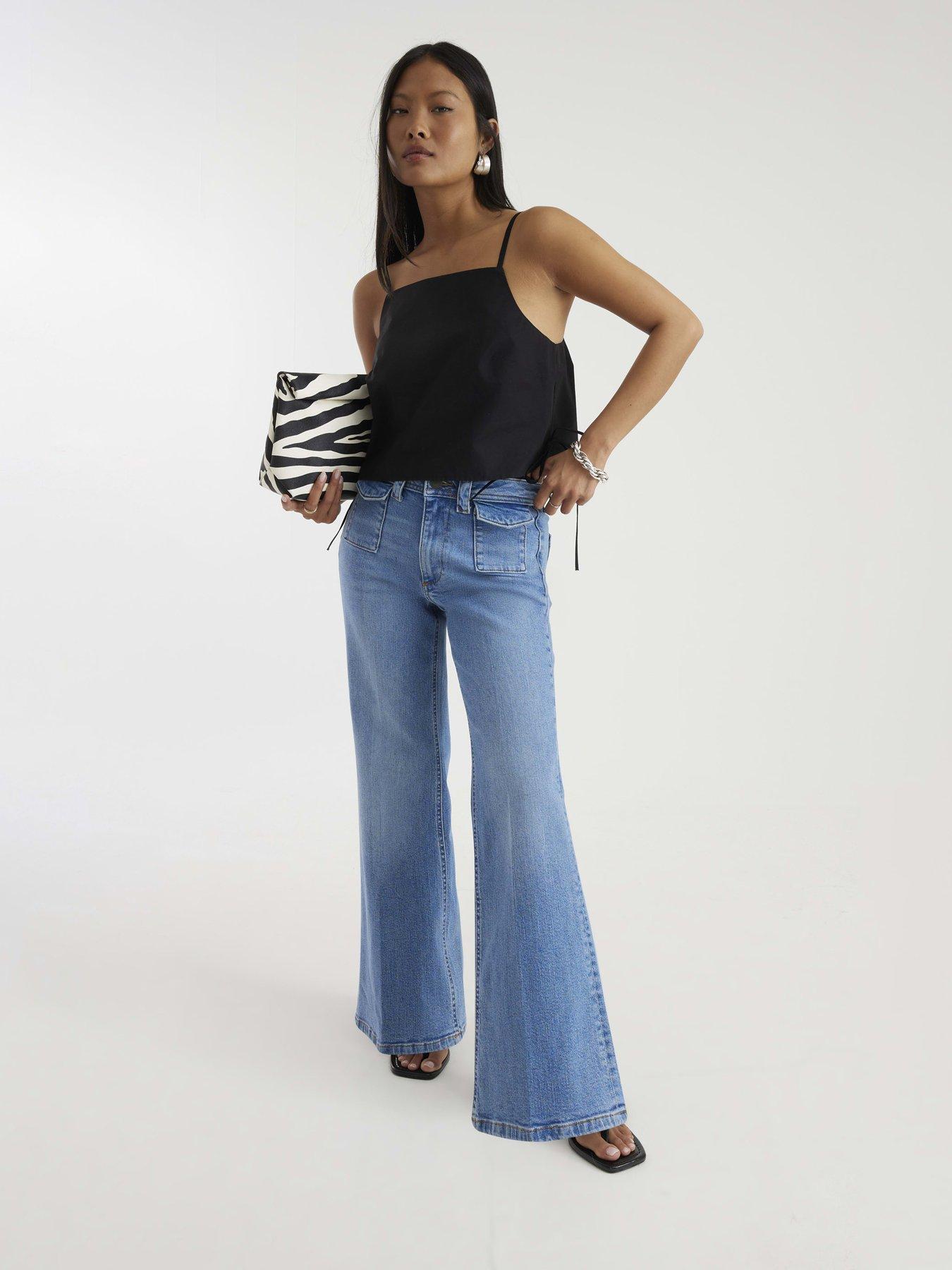 Image 1 of 4 of River Island Petite Denim High Waisted Relaxed Flare Jeans
