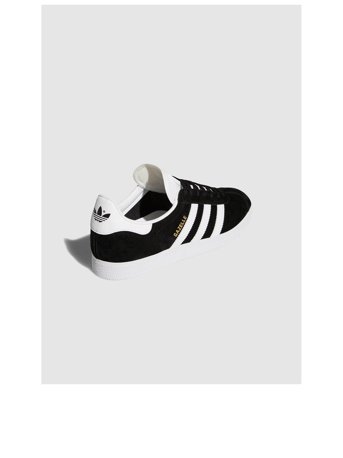 white and black adidas trainers