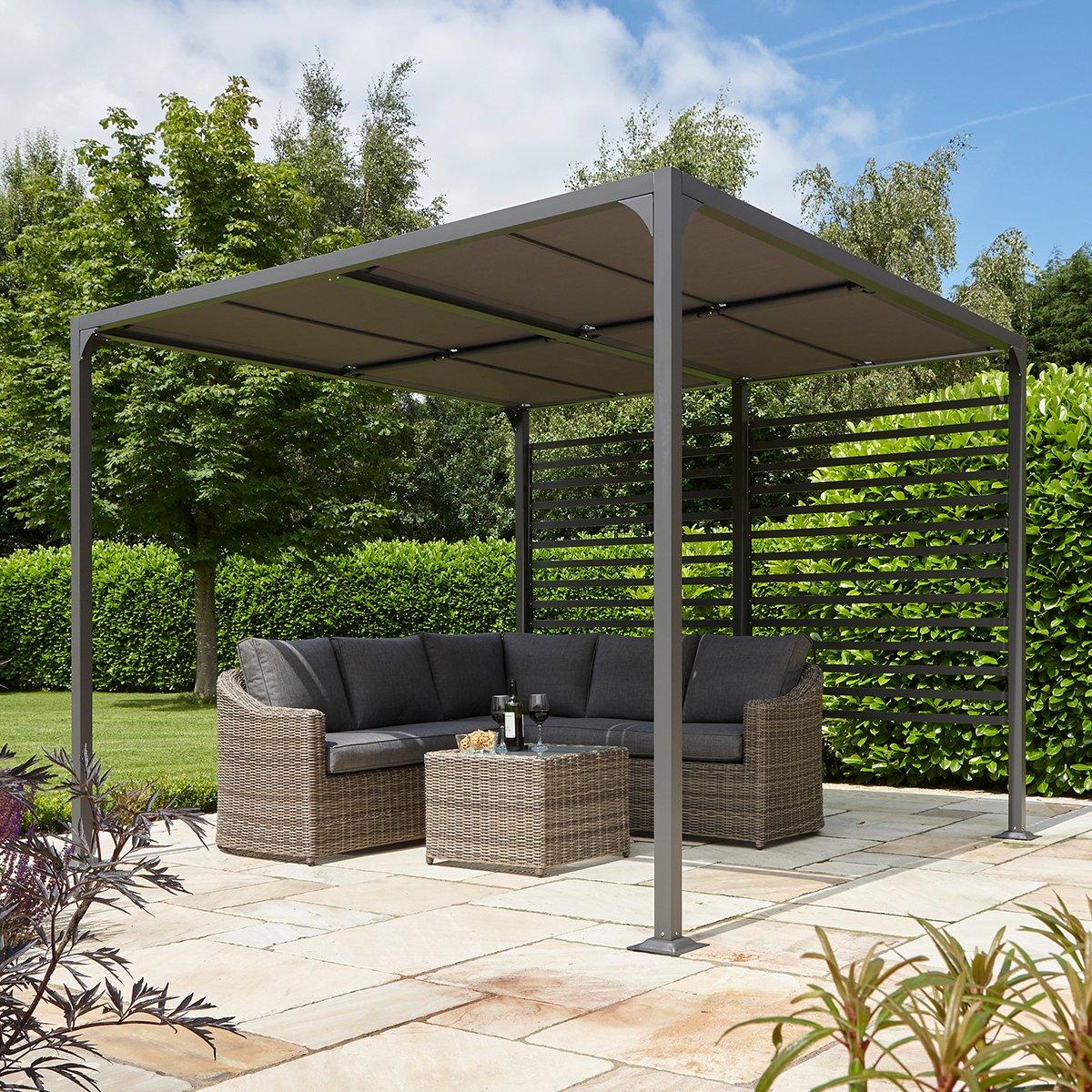 Modern outdoor patio with a sleek patio cover over the top. Rattan sofa and table set on stone tiles.
