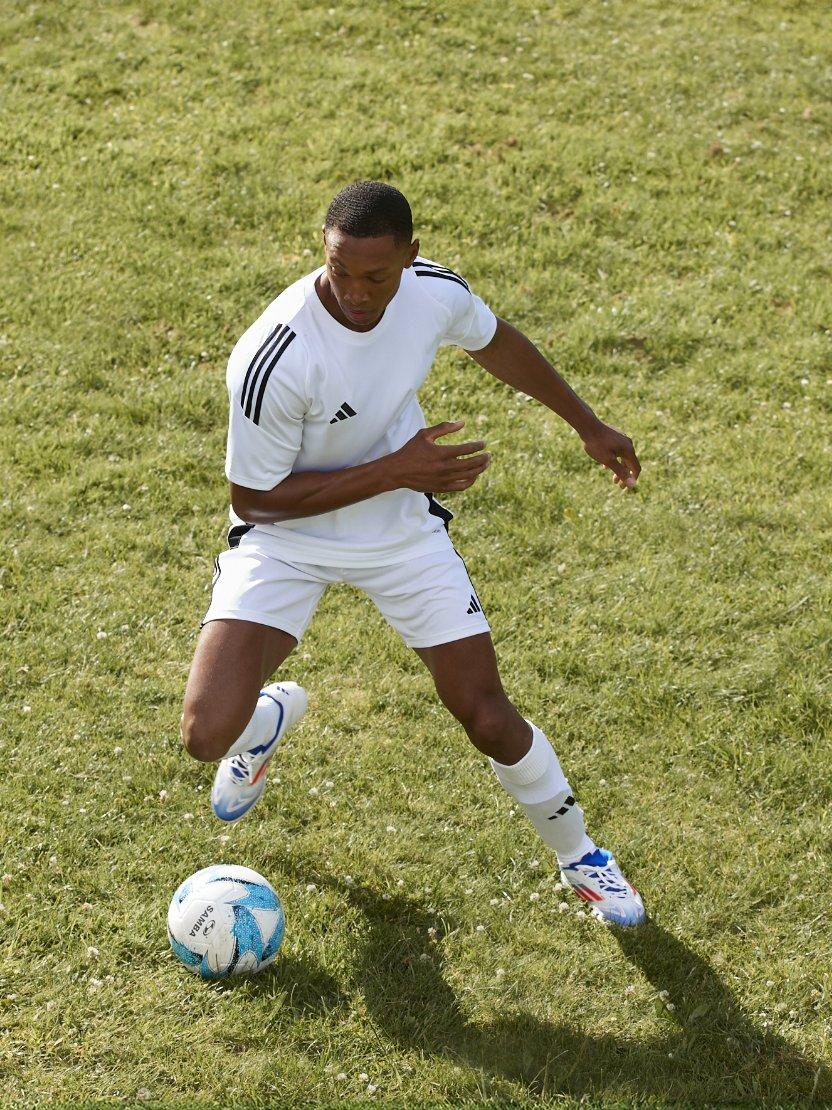 Man playing football on a grassy field