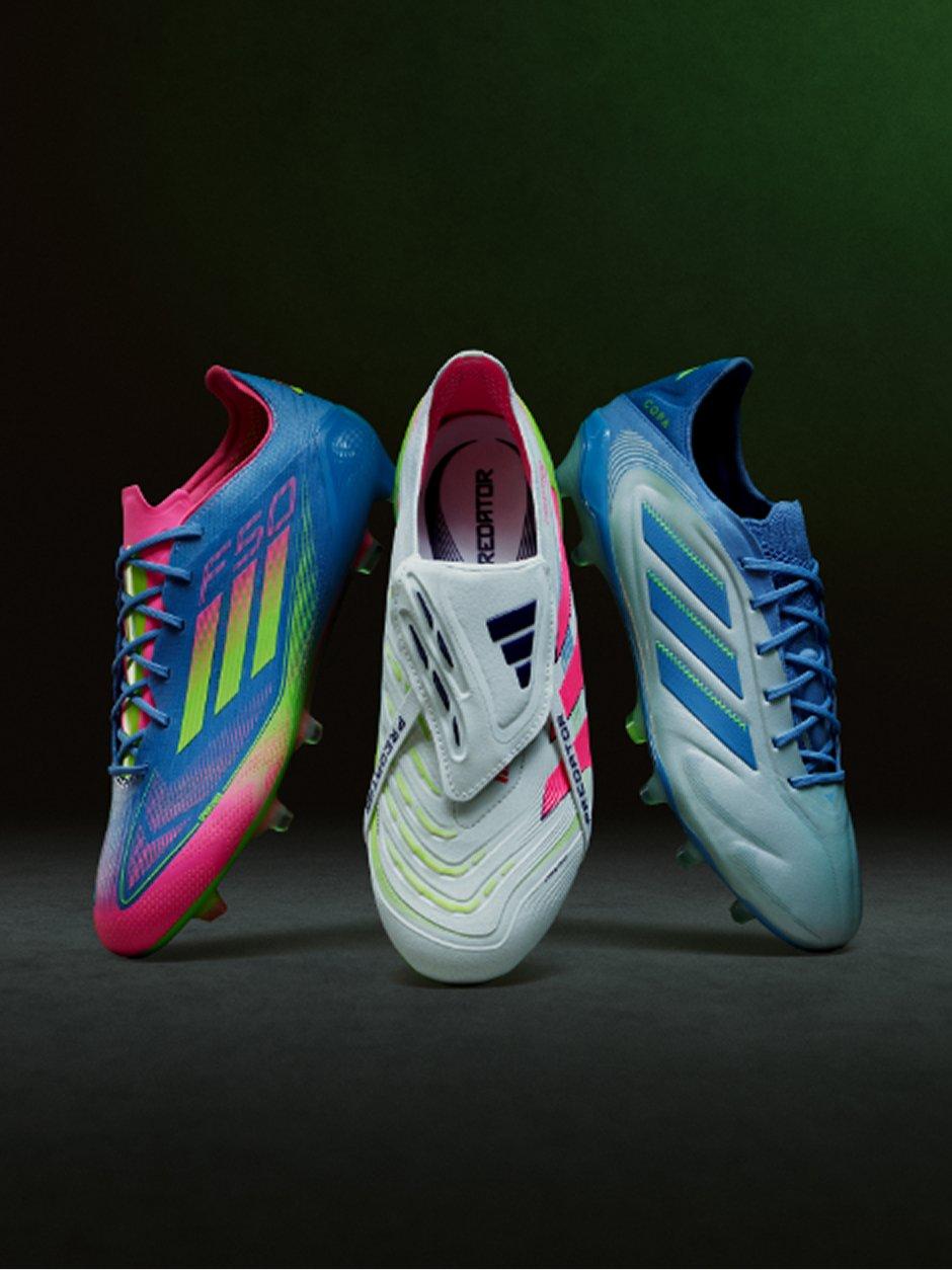 Three pairs of adidas football boots on display