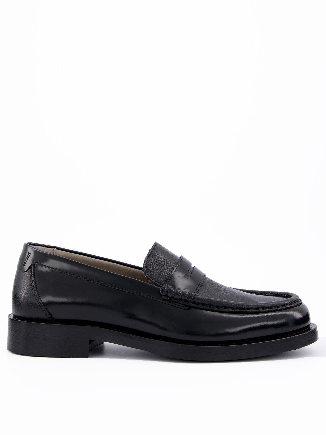Side view of a mans black formal shoe that are a chunky loafer on a white background