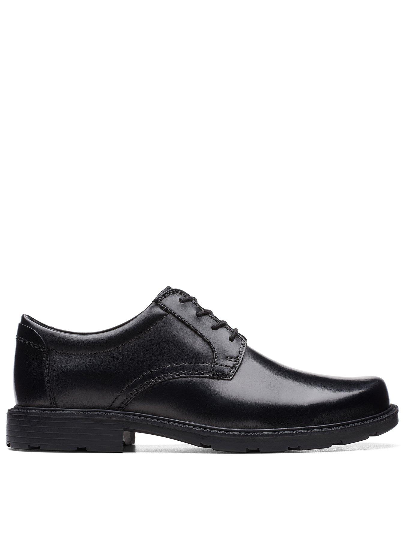 Side view of a mans black formal shoe with black laces on a white background