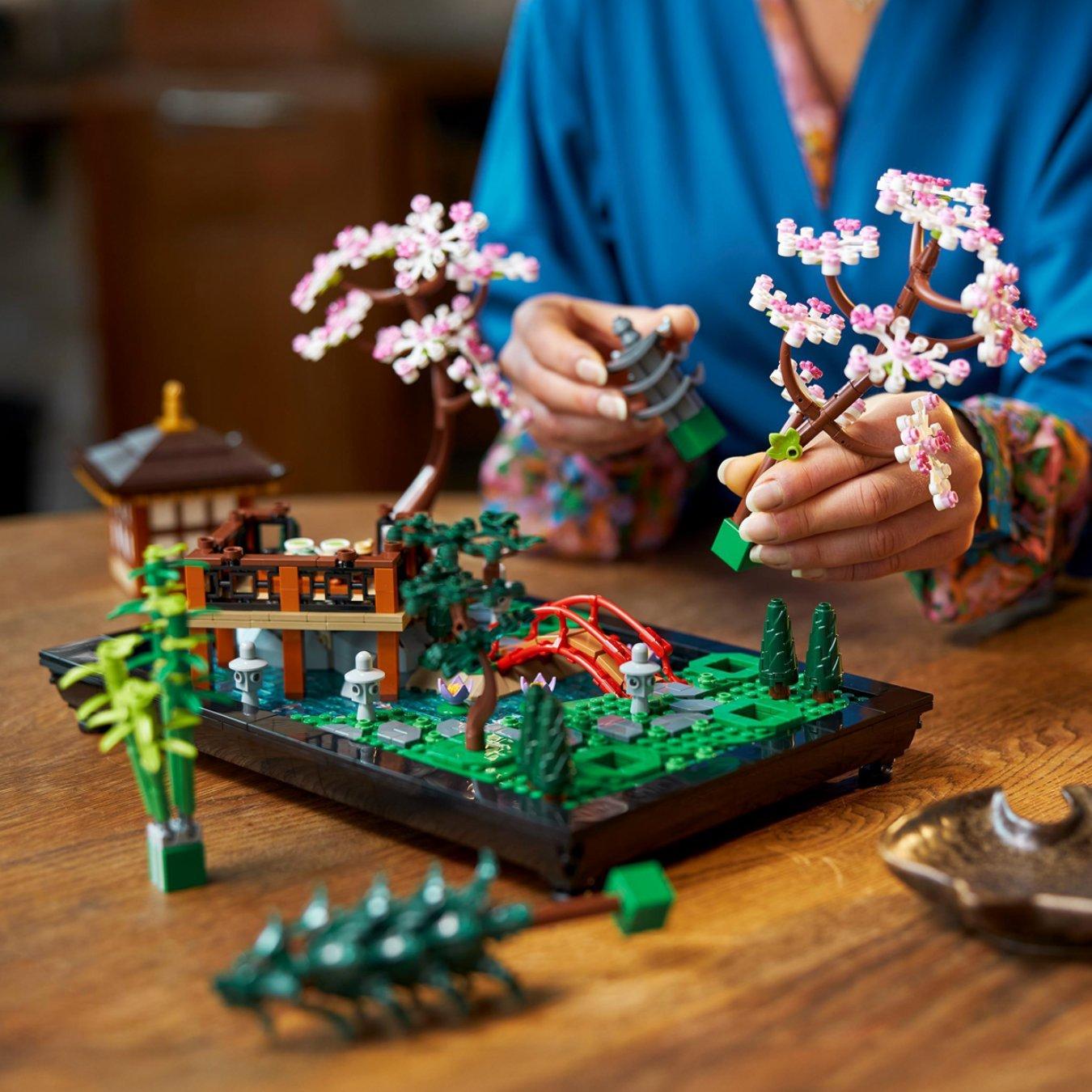 Image of a woman building LEGO Botanical Tranquil Garden