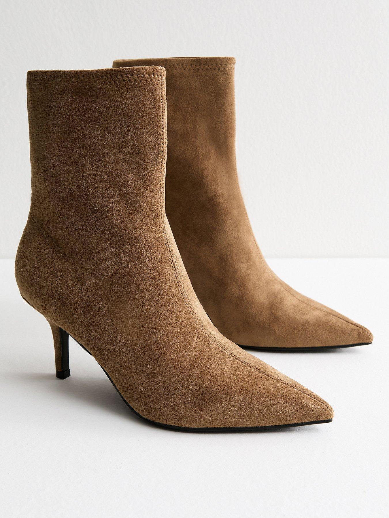 Pair of suede  style ankle boots with a low heel and in a sandy colourway.