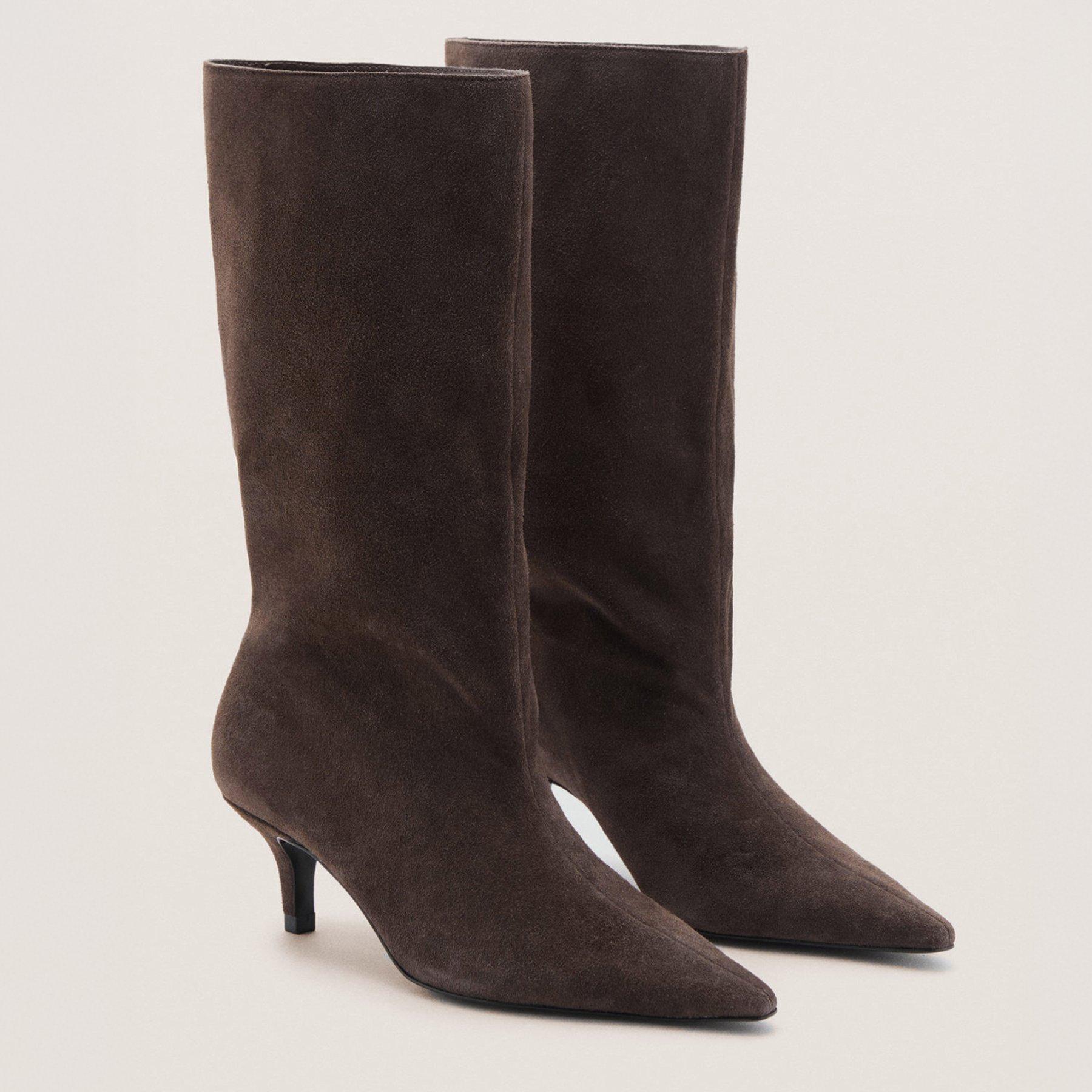 A pair of suede knee high boots with a small heel. An ideal footwear option for your date night outfit.
