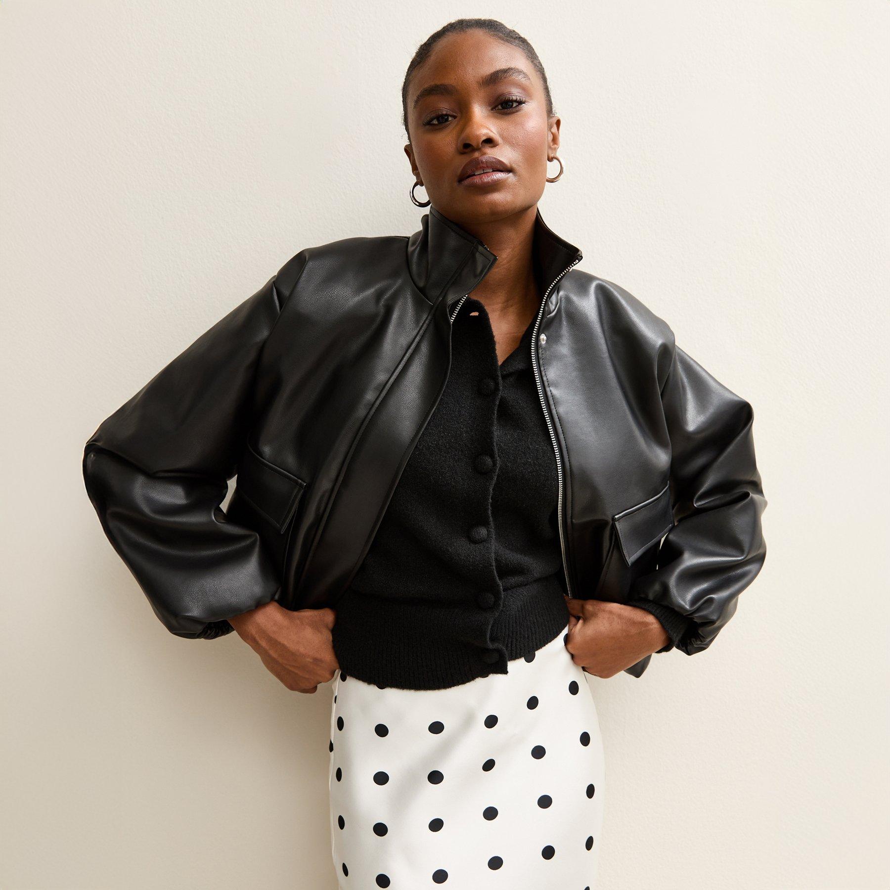 Model poses showing off her oversized black leather jacket