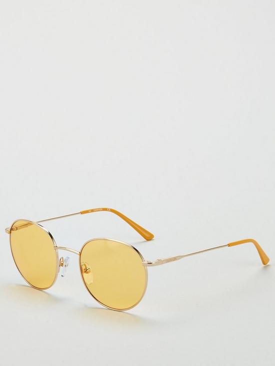front image of calvin-klein-round-maize-sunglasses