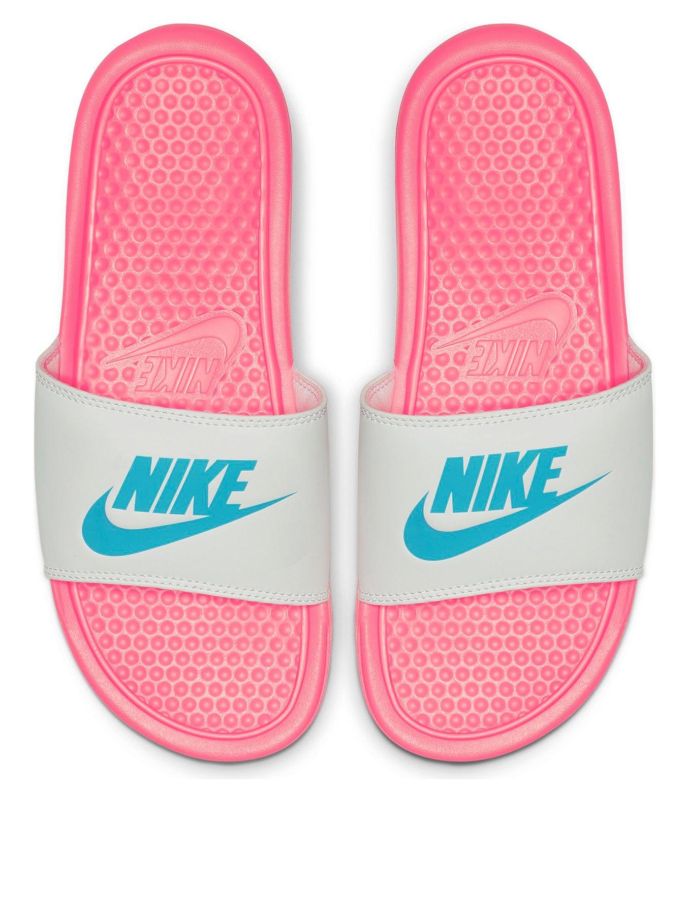 pink and white nike flip flops