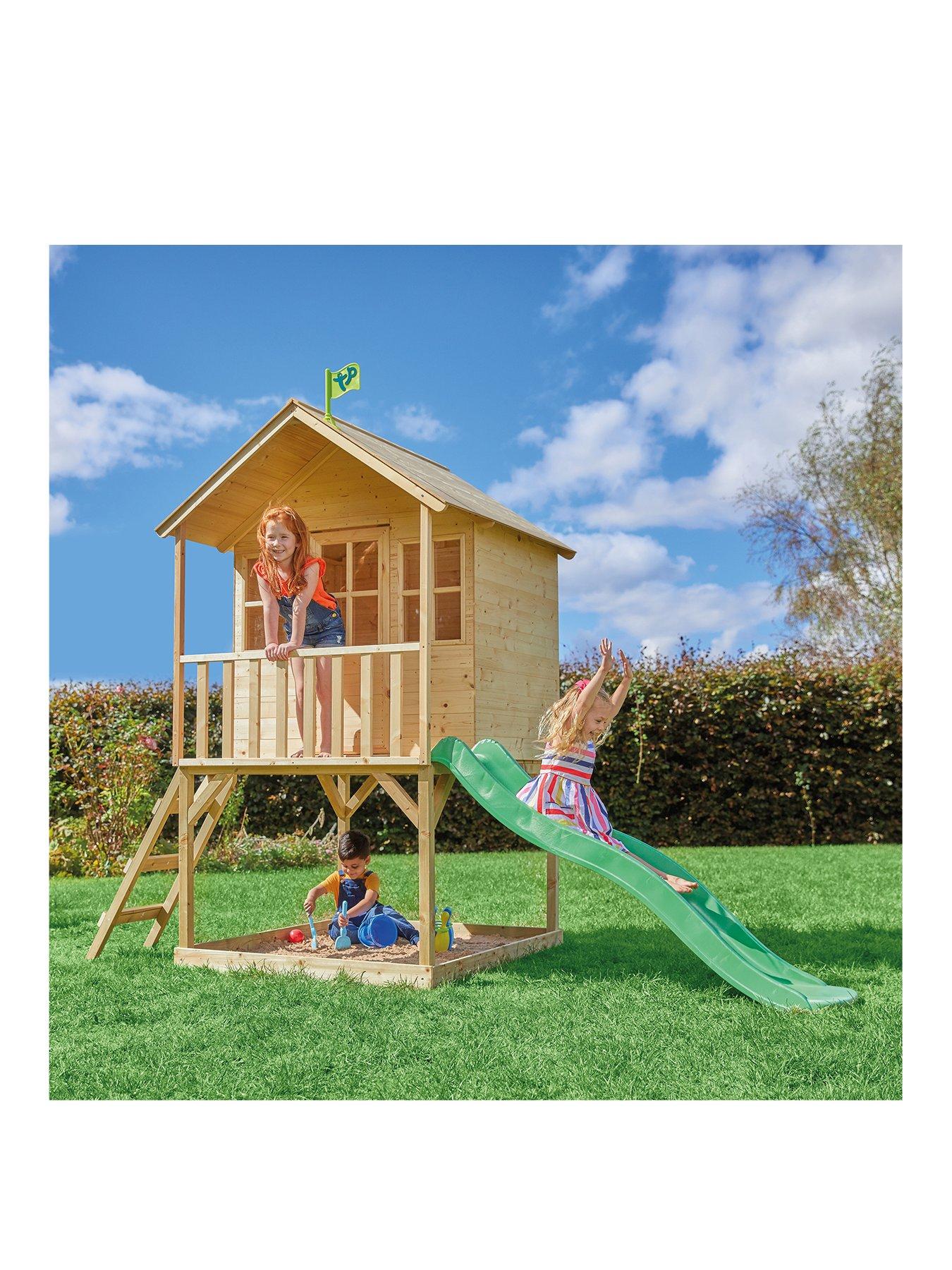 wooden playhouse with slide and sandpit