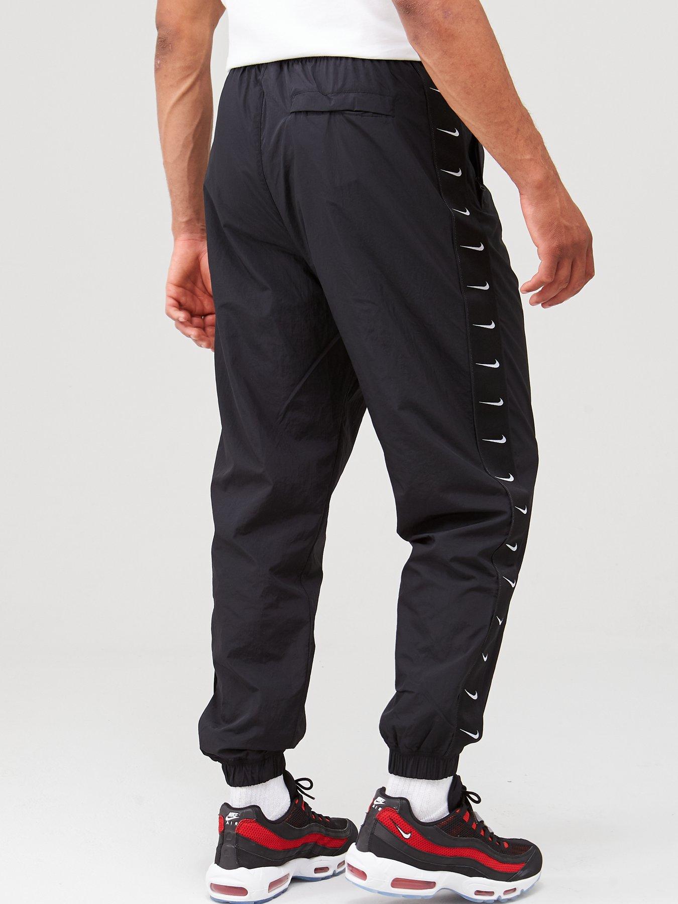 nike woven taping cuffed joggers in black