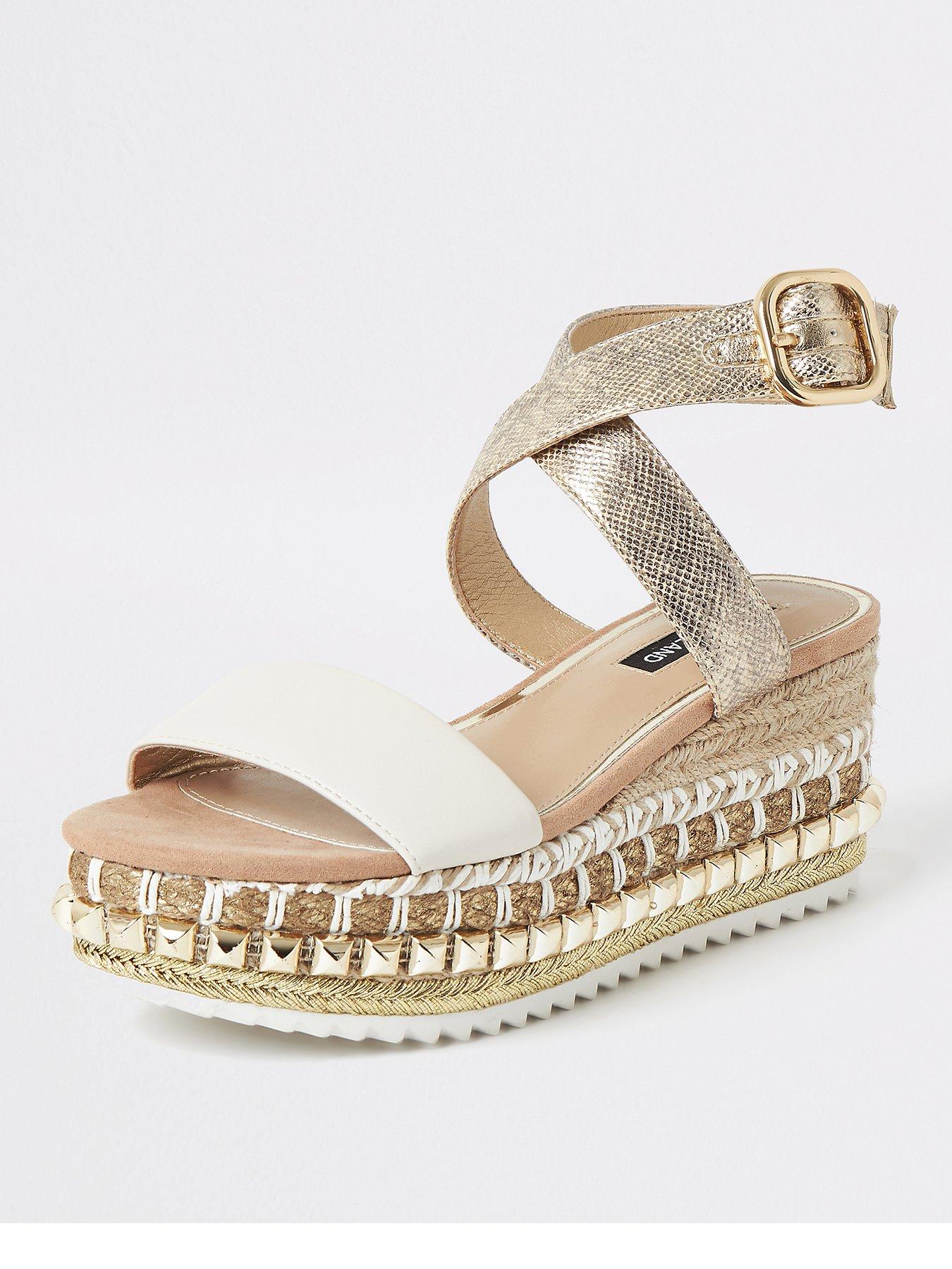 white and gold flatforms