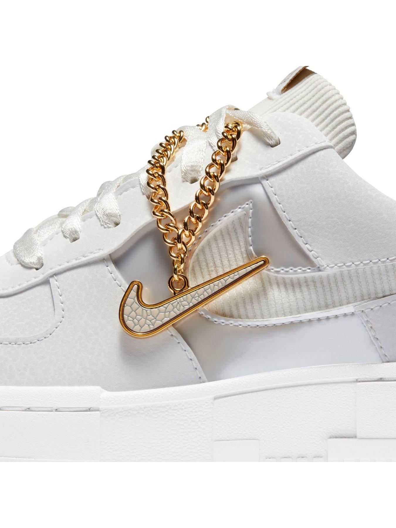 gold and white nike trainers