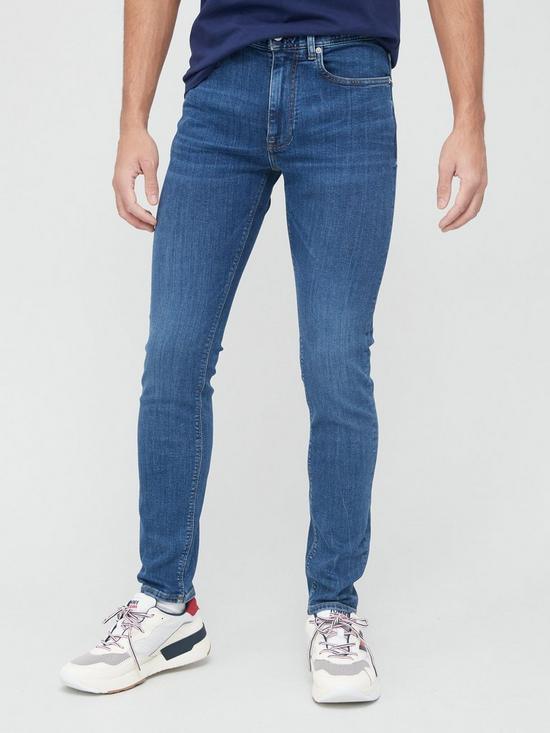 front image of tommy-hilfiger-slim-fit-bleecker-power-stretch-oregon-indigo-jeans-mid-wash