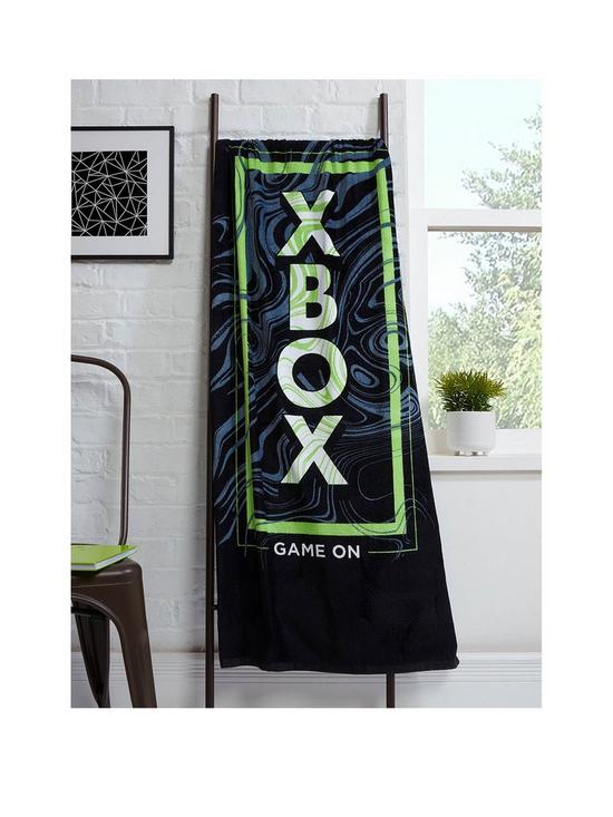 front image of xbox-x-box-game-on-towel