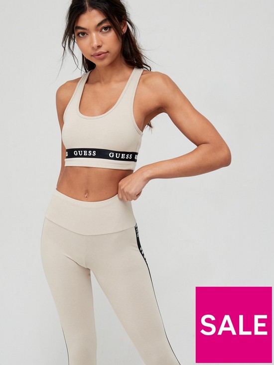 front image of guess-logo-taping-sports-bra-stone