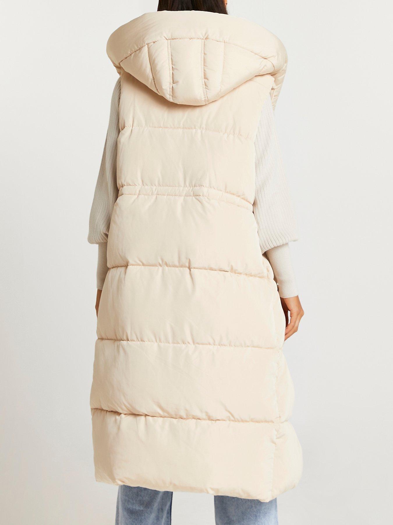 long cream body warmer