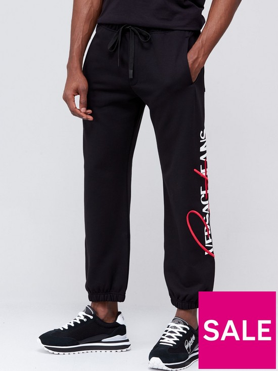 front image of versace-jeans-couture-embroidered-logo-joggers-black