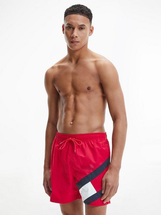 front image of tommy-hilfiger-solid-flag-swim-shorts-red