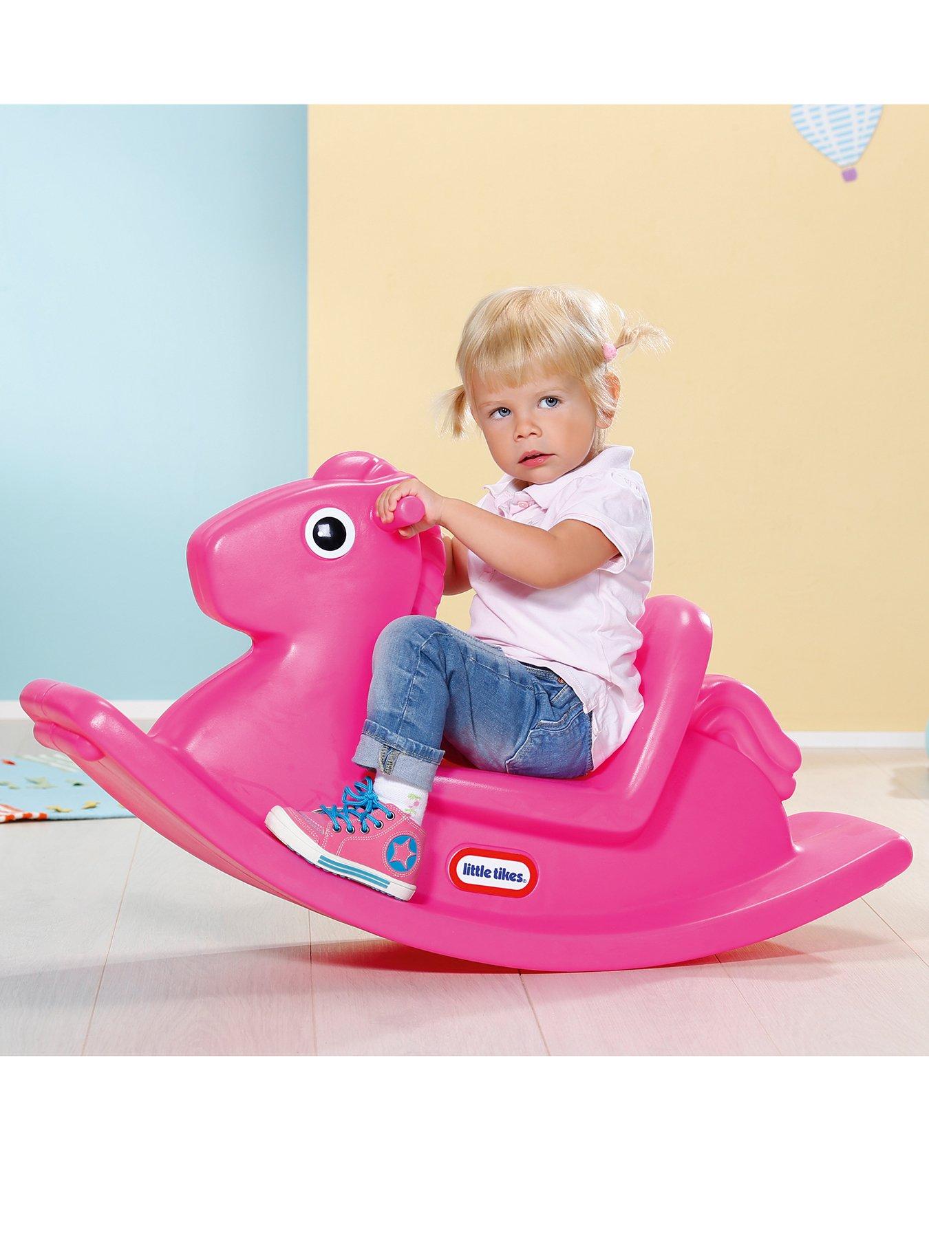 Pink plastic store rocking horse