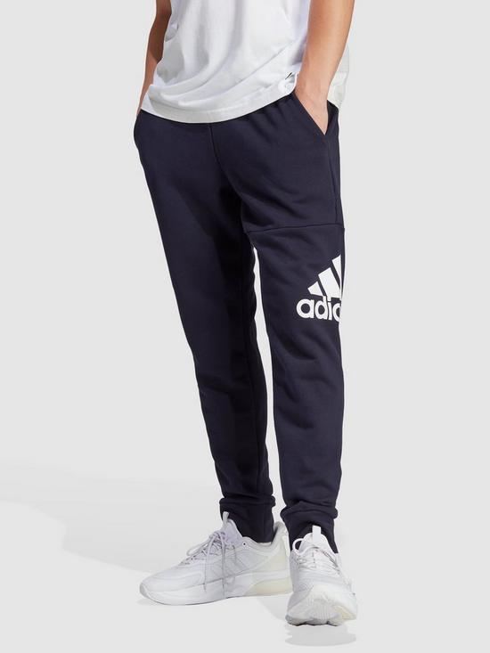 front image of adidas-sportswear-essentials-french-terry-tapered-cuff-logo-joggers-navy