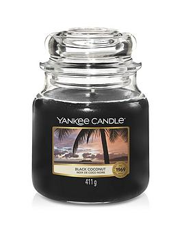 Product photograph of Yankee Candle Black Coconut Medium Classic Jar Candle from very.co.uk