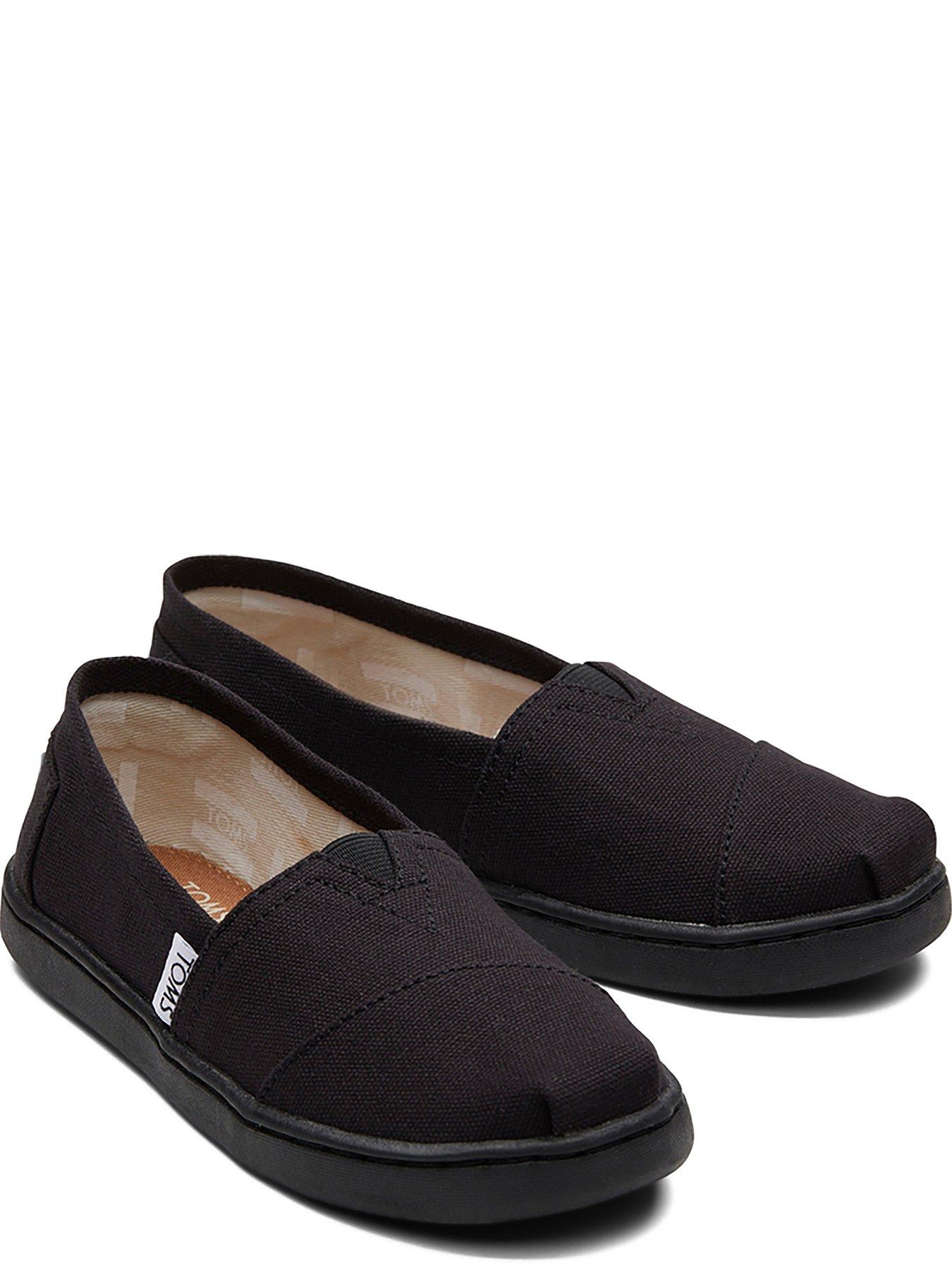 Toms black store on black canvas