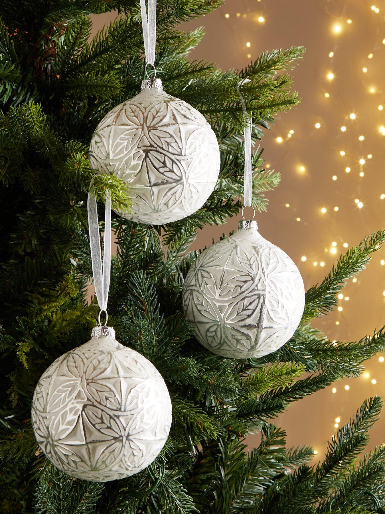 Green Light Green Needles Grow On A Real Christmas Tree. The Christmas Tree  Is Decorated With Red Beads, Bows And Glass Balls. Beautiful Elegant Christmas  Tree Glitters And Shimmers In Natural Sunlight.