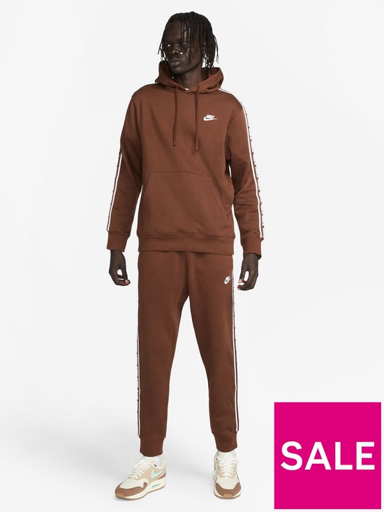 front image of nike-club-fleece-tracksuit-brown