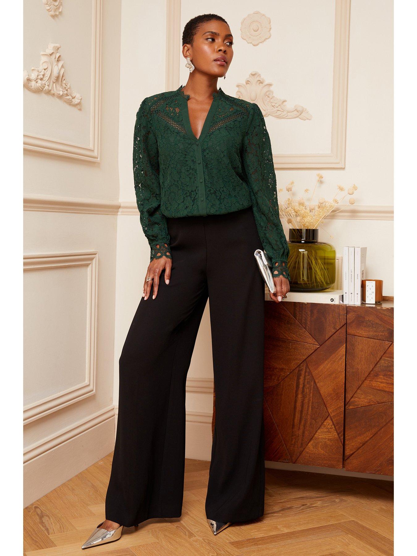 Green blouse store and black pants