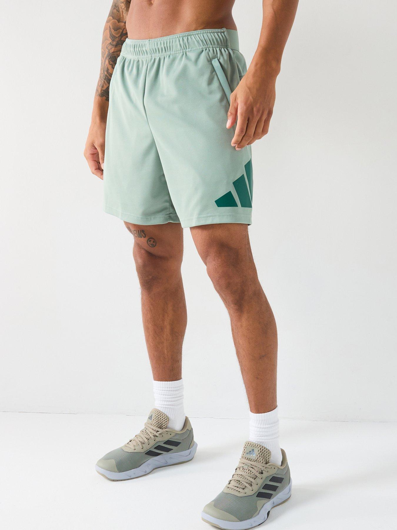 Image 1 of 6 of adidas Men's Train Essentials 7 Inch Logo Shorts - Silver Green/Collegiate Green