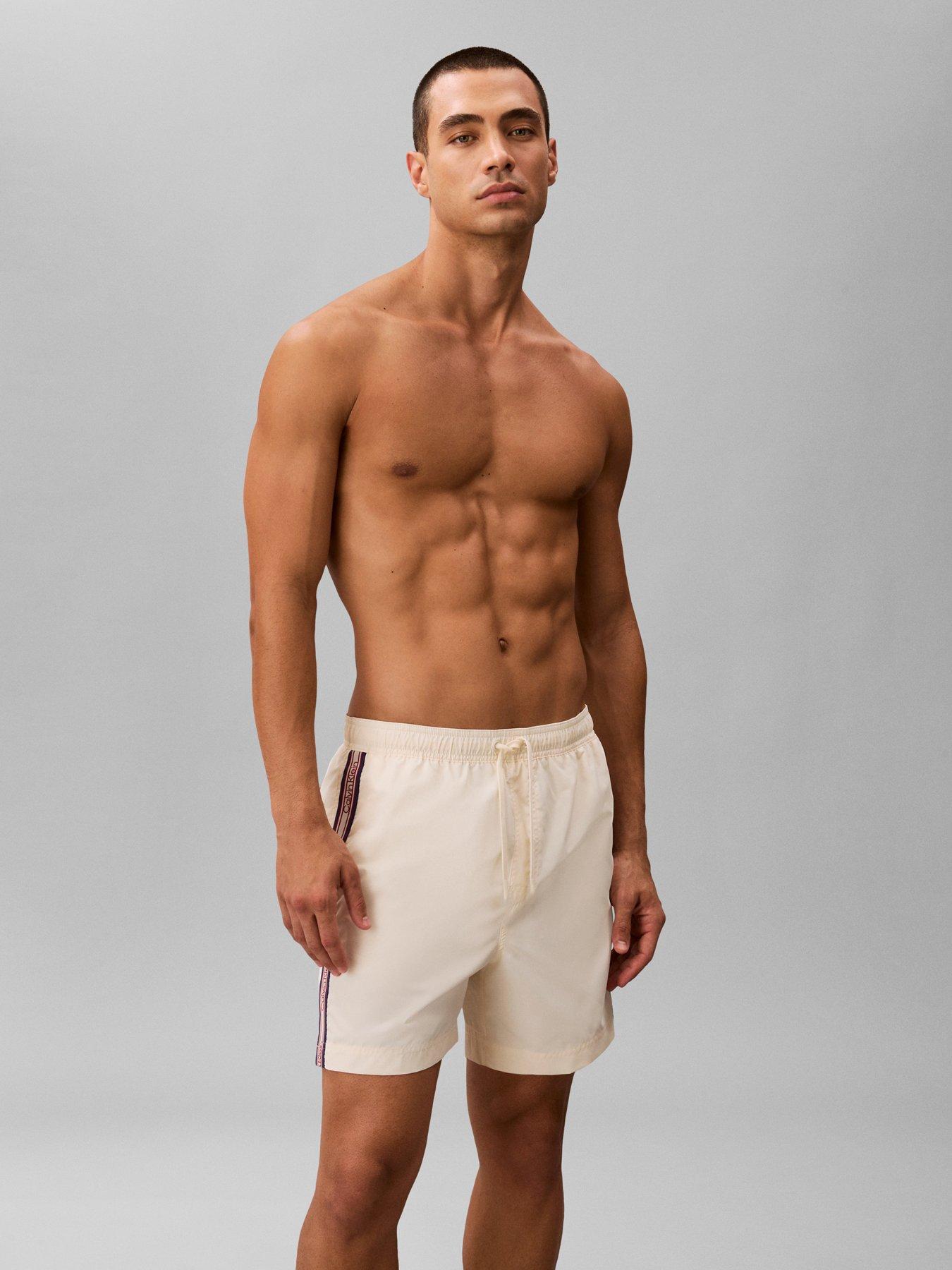 Image 1 of 4 of Calvin Klein Retro Sport Side Tape Logo Medium Swim Shorts - Beige