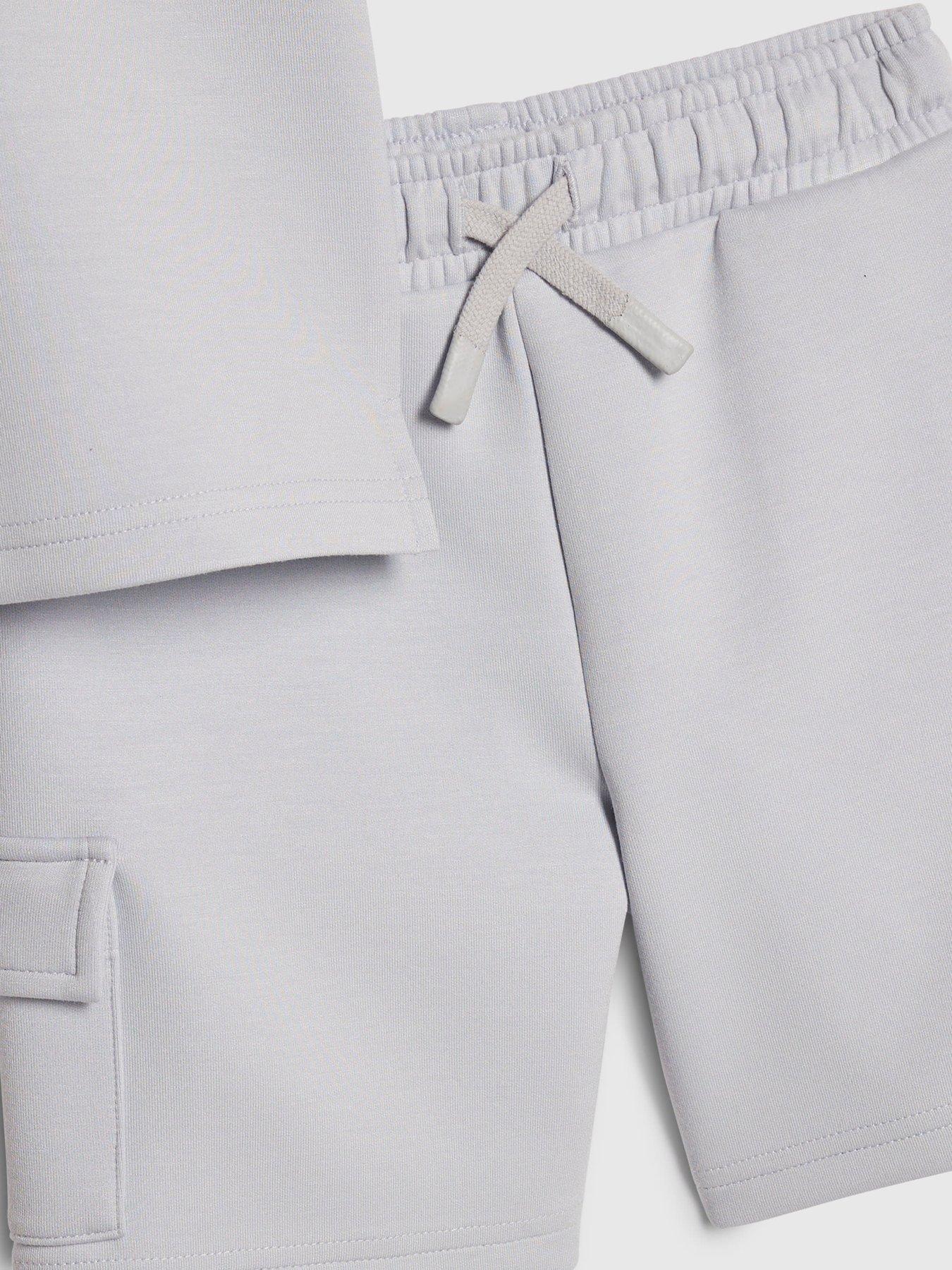 Image 4 of 5 of River Island Mini Mini Boys Luminis Badge Polo T-Shirt &amp; Shorts Set - Light Blue
