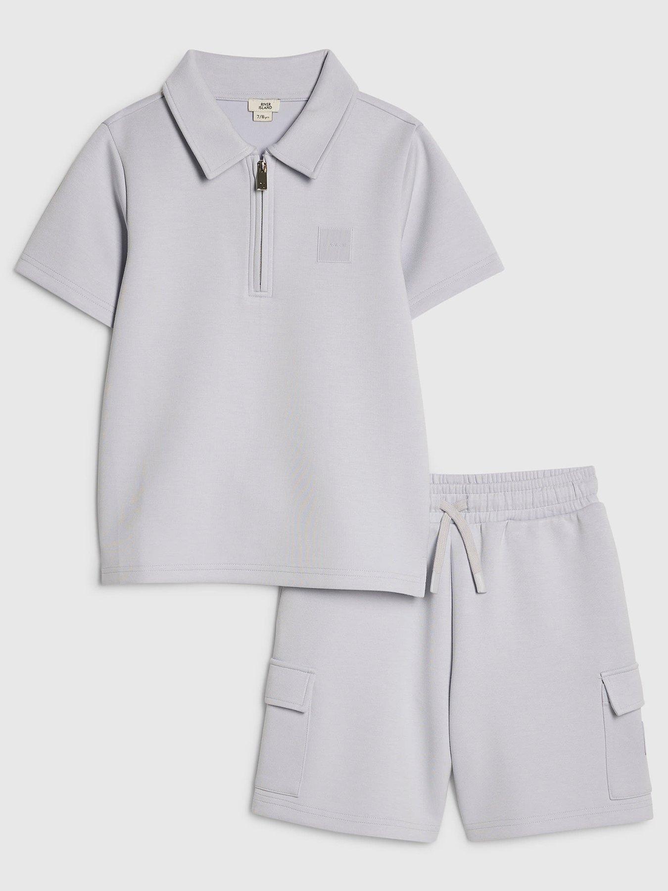 Image 1 of 5 of River Island Older Boys Luminis Badge Polo T-Shirt &amp; Shorts Set&nbsp;- Light Blue