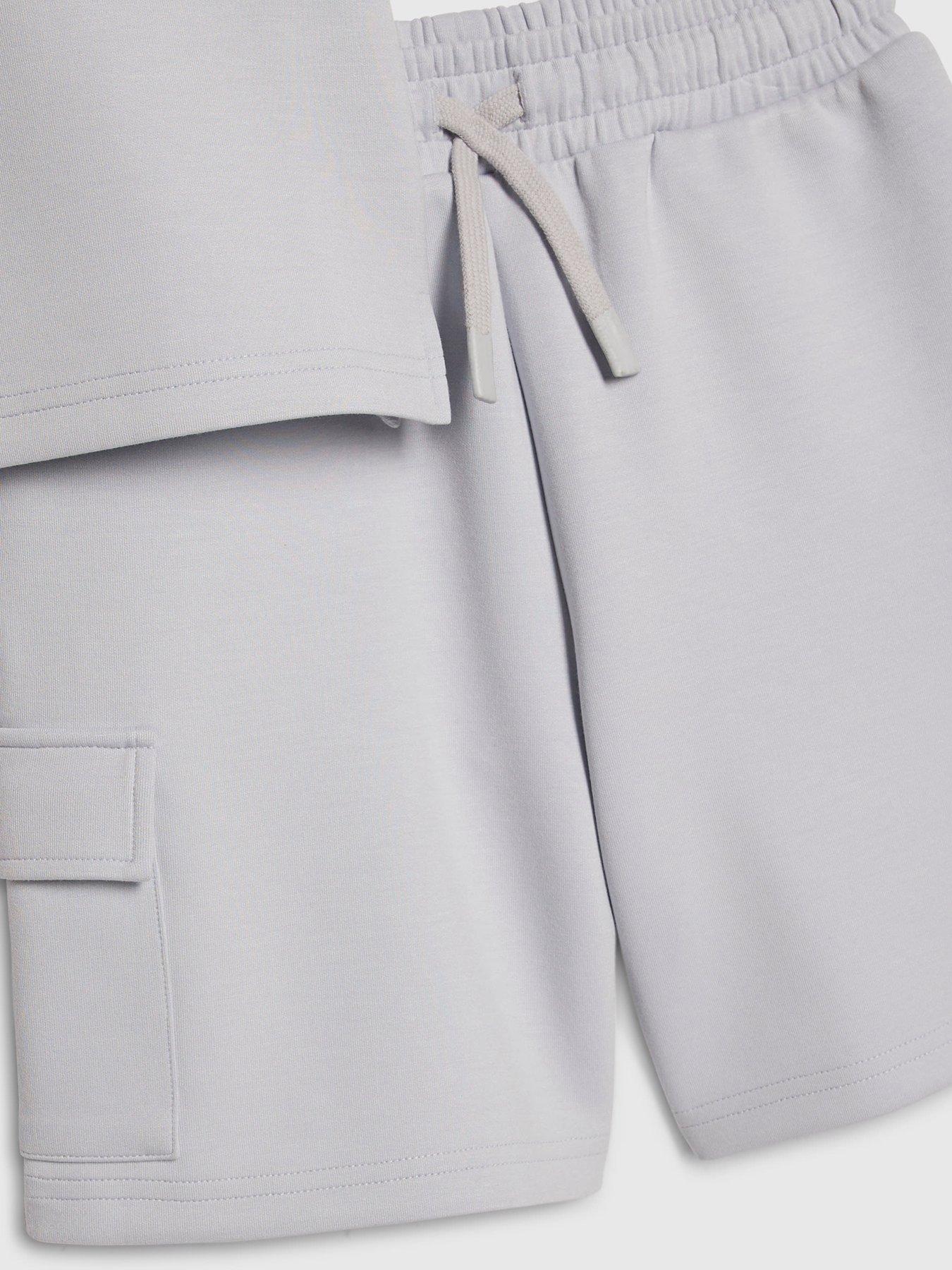 Image 4 of 5 of River Island Older Boys Luminis Badge Polo T-Shirt &amp; Shorts Set&nbsp;- Light Blue