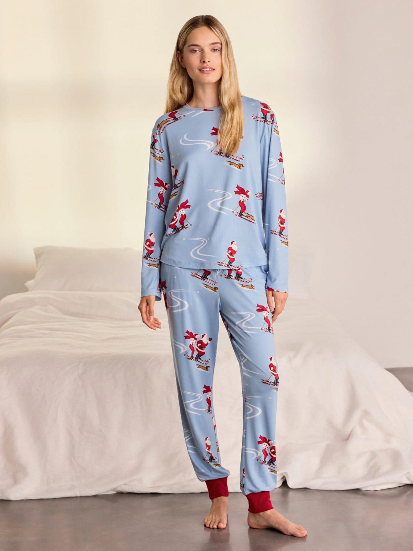 Image 1 of 7 of CHELSEA PEERS Womens Christmas Skiing Santa Print Long Pyjama Set - Blue