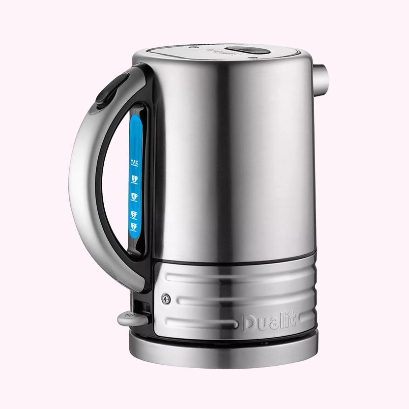 Close-up of the Dualit Architect Brushed Stainless Steel kettle set onto a light pink background.